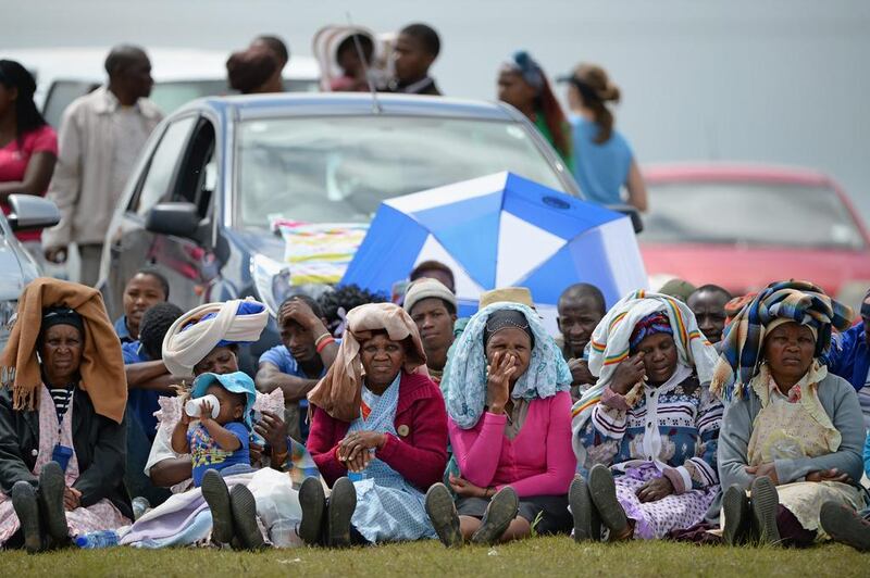 People watch big screens at the site of where Mandela will be buried. Jeff J Mitchell / Getty Images