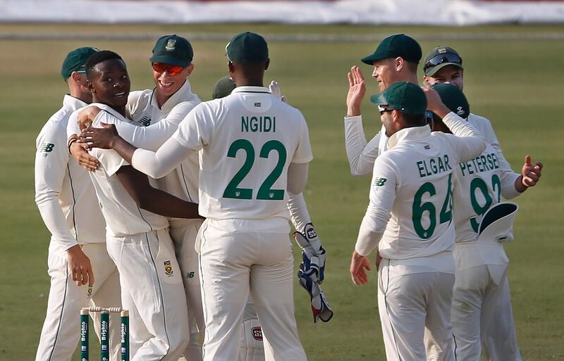 South Africa bowler Kagiso Rabada, second left, celebrates with teammates after taking the wicket of Pakistan opener Imran Butt during the opening day of the first Test in Karachi, on Tuesday, January 26. AP
