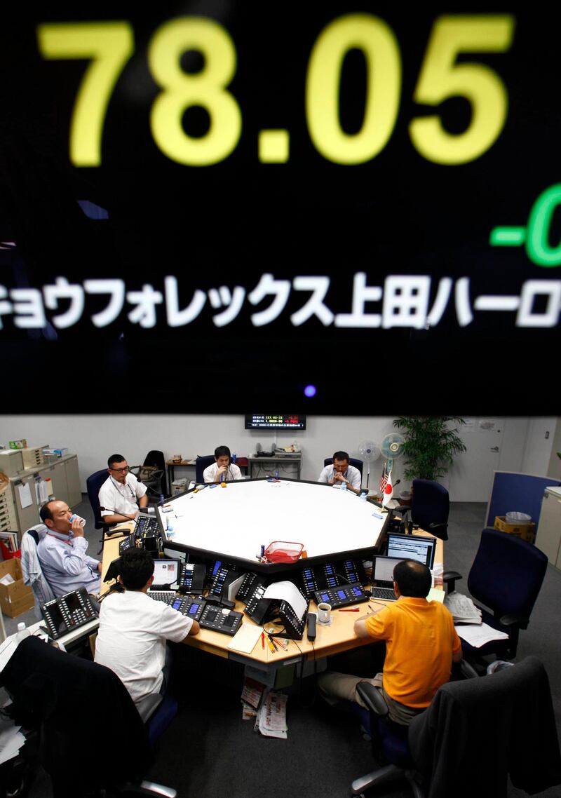 Money traders work under a currency rate indicator showing the yen-dollar exchange rate at a money market brokerage company in Tokyo, Japan, Tuesday, July 26, 2011. The dollar slid further Tuesday, amid the U.S. debt deadlock. President Barack Obama described in a televised speech Monday night his country as being dangerously close to default. (AP Photo/Shizuo Kambayashi)