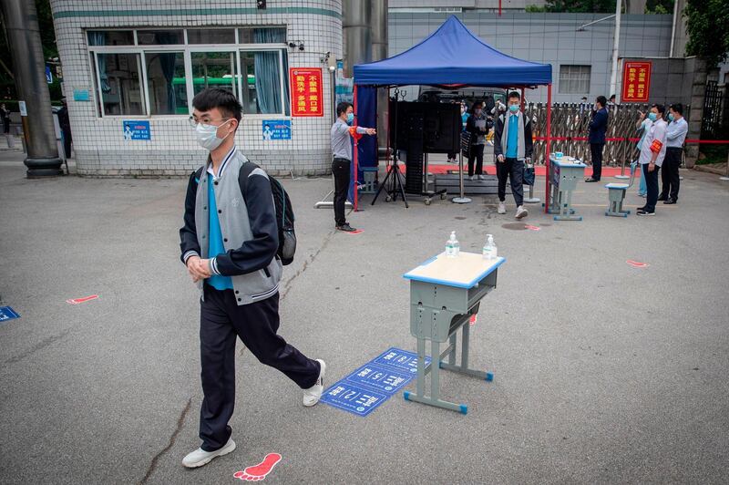 Senior pupils enter a high school in Wuhan in China's central Hubei province. AFP