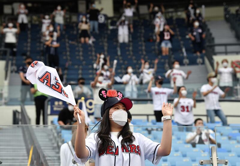 Baseball fans cheer as they observe social distancing during the KBO league baseball game between Seoul-based Doosan Bears and LG Twins at Jamsil stadium. AFP
