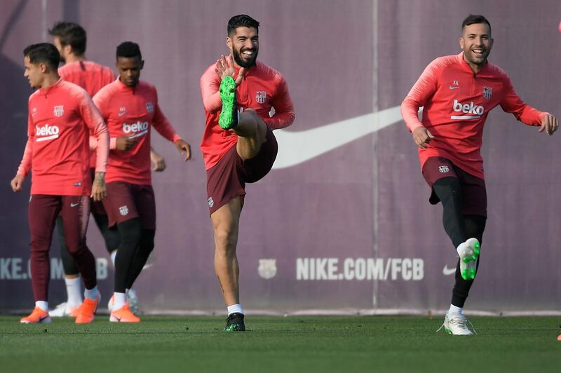 Luis Suarez and Lionel Messi go through a warm-up during the training sesion. AFP