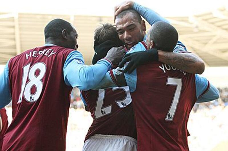 John Carew, second right, is mobbed by his teammates after his hat-trick goal.
