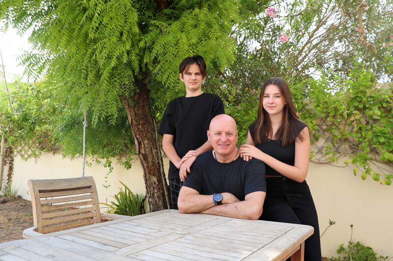 Thomas Simpson, who has reunited with his family in Dubai after being held in Iraq since July last year, with his children Jamie, 16, and Kane, 13.