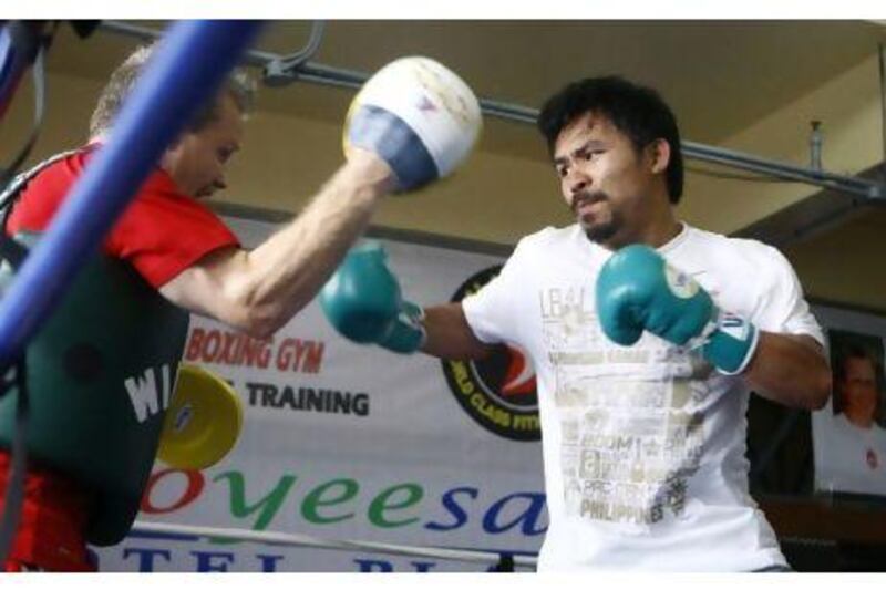 Manny Pacquiao, right, and Freddie Roach at a training facility in the Philippines. Pacquiao defeated Shane Mosley in their WBO welterweight title fight in Las Vegas.