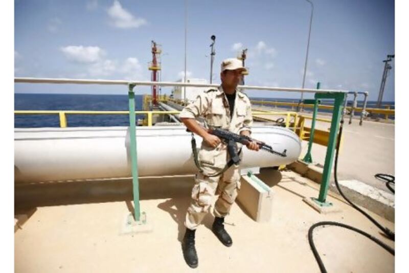 An anti-Gaddafi fighter stands guard at the Mellitah Oil and Gas complex during a handover ceremony in Mellitah, 80km west Tripoli this week. Reuters