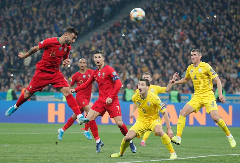 epa07920937 Bruno Fernandes (L) of Portugal and Taras Stepanenko (C-R) of Ukraine in action during the UEFA Euro 2020 qualifying, group B, soccer match between Ukraine and Portugal in Kiev, Ukraine, 14 October 2019.  EPA/SERGEY DOLZHENKO