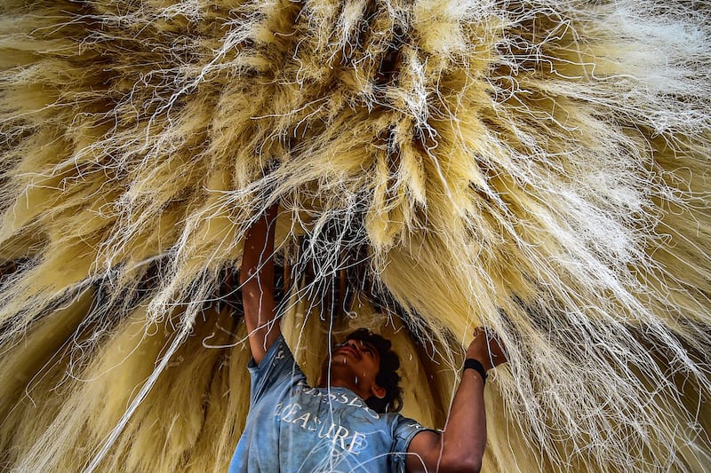 An Indian worker stacks vermicelli at a factory in Allahabad, India.  AFP