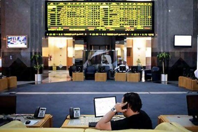 An investor monitors stocks on the Abu Dhabi Securities Exchange. Trading activity and market interest in the country's bourses have improved this year. Sammy Dallal / The National