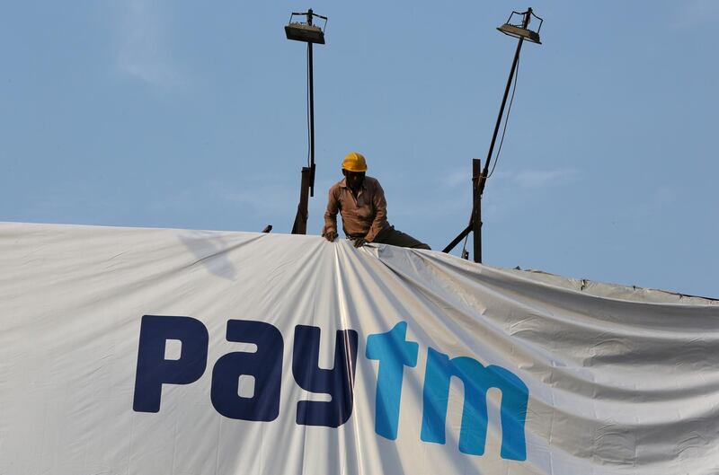 FILE PHOTO: A worker adjusts a hoarding of Paytm, a digital payments firm, in Ahmedabad, India, January 31, 2019.  REUTERS/Amit Dave/File Photo