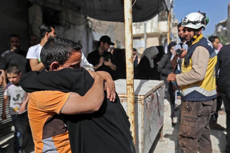 Prisoners held by the Syrian government reunite with relatives during a prisoner exchange between the Syrian government and Hayat Tahrir al-Sham (HTS) in the countryside of the rebel-held Idlib province on May 17, 2019.  / AFP / OMAR HAJ KADOUR
