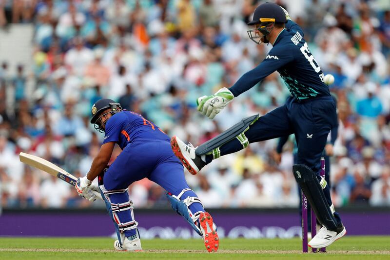 India captain Rohit Sharma plays a shot past England wicketkeeper Jos Buttler. AFP