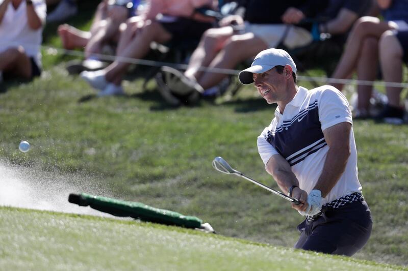 Rory McIlroy hits from a bunker on the ninth. AP