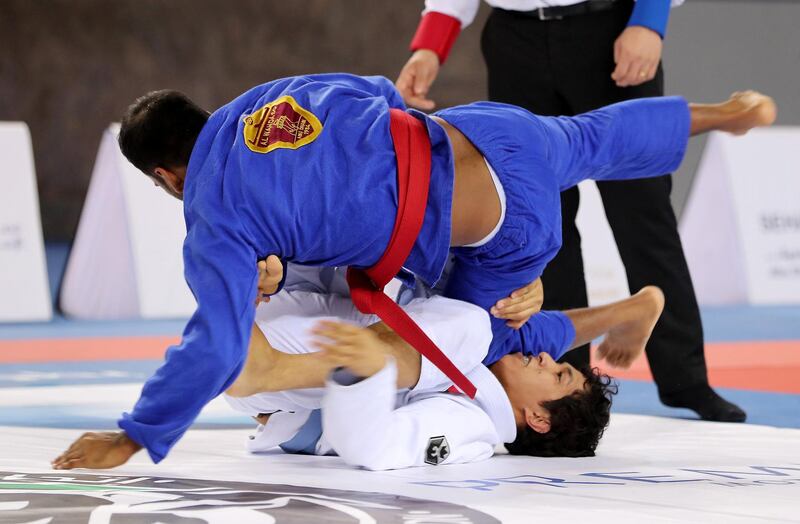 ABU DHABI , UNITED ARAB EMIRATES, September 29 , 2018 :- Ahmed Khamis Aljunaibi ( blue ) of Al Wahda Club and Naser Al Breiki ( white ) of A.F.N.T during the men seniors category game in the Jiu-Jitsu President’s Cup Round -1 held at Al Jazira Club Indoor stadium in Abu Dhabi. Naser Al Breiki won the game. ( Pawan Singh / The National )  For Sports. Story by Amith