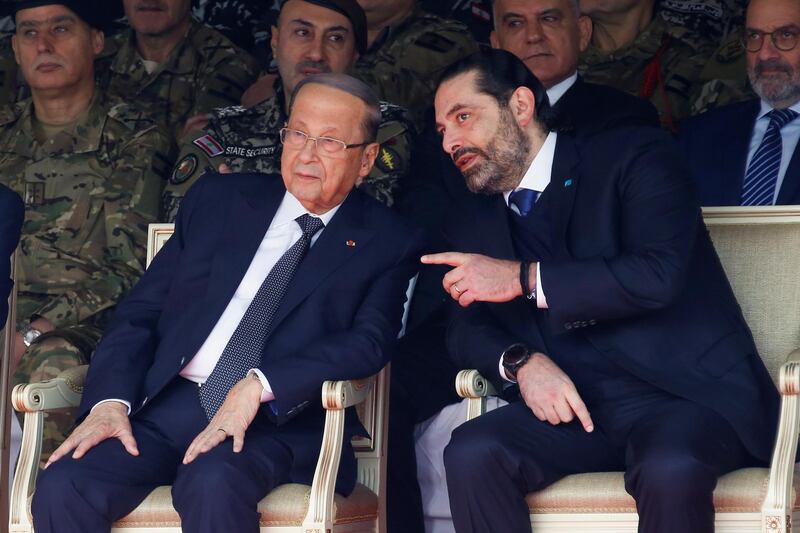 Mr. Hariri chats with Mr. Aoun during a military parade. Reuters