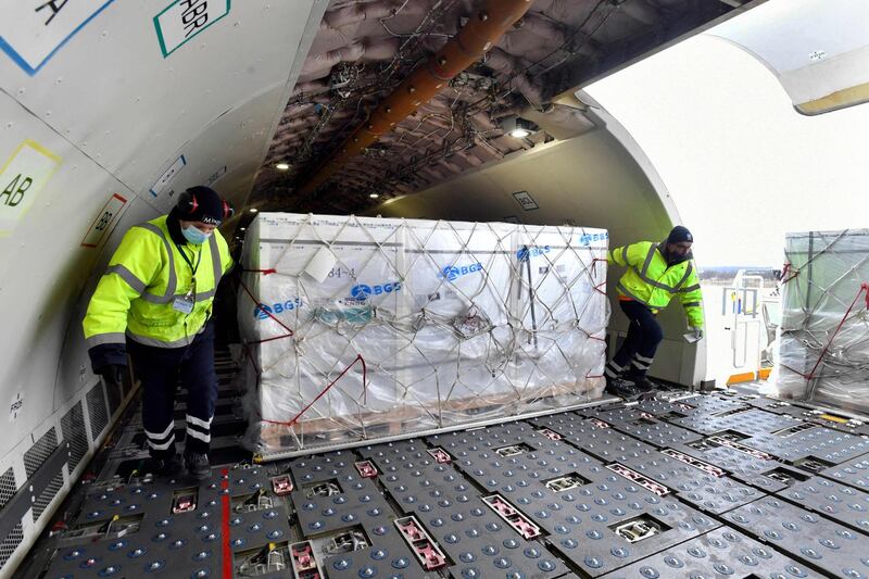 Workers unload the cargo of a Hungarian Airbus 330 plane, having transported the first doses of the Chinese Sinopharm vaccine at Budapest Ferenc Liszt International Airport. AFP