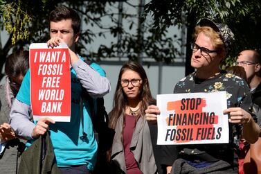 Protestors outside the World Bank demonstrate against financing fossil fuels and demanding investment in renewable energy, during the IMF and World Bank's 2019 annual meetings of finance ministers and bank governors, in Washington. Reuters