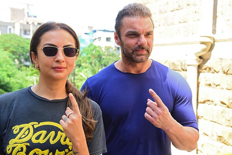 Bollywood actor Sohail Khan with his wife Seema Khan show their inked fingers after casting his vote at a polling station during the state assembly election, in Mumbai on October 21, 2019. AFP / Sujit Jaiswal