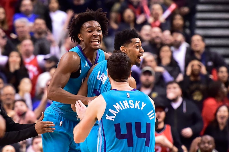 Charlotte Hornets guard Jeremy Lamb, middle, celebrates his game-winning basket against the Toronto Raptors with teammates Devonte' Graham, left, and Frank Kaminsky in an NBA basketball game Sunday, March 24, 2019, in Toronto. (Frank Gunn/The Canadian Press via AP)