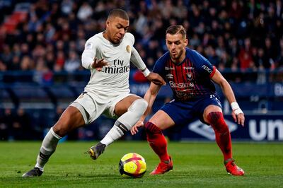 Paris Saint-Germain's French forward Kylian Mbappe (L) vies for the ball with Caen's French defender Jonathan Gradit during the French L1 football match between Caen (SMC) and Paris Saint-Germain (PSG) at the Michel d'Ornano Satdium in Caen, northwestern France, on March 2, 2019. / AFP / CHARLY TRIBALLEAU
