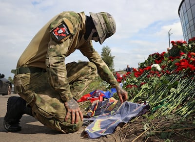 A Wagner Group mercenary visits a makeshift memorial in St Petersburg after the death of Yevgeny Prigozhin. Reuters