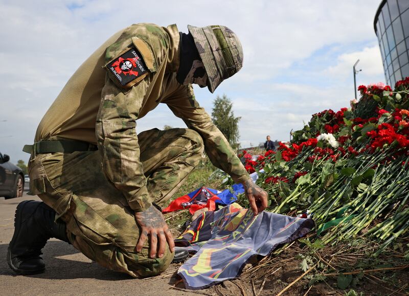A Wagner fighter visits a makeshift memorial to Yevgeny Prigozhin in St Petersburg, Russia. Reuters