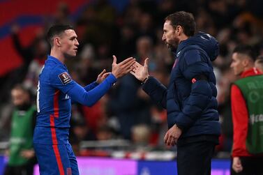 Englands's midfielder Phil Foden (L) shakes hands with England's manager Gareth Southgate (R) as he's substituted during the FIFA World Cup 2022 Group I qualifier football match between England and Albania at Wembley Stadium in London on November 12, 2021.  (Photo by Glyn KIRK  /  AFP)  /  NOT FOR MARKETING OR ADVERTISING USE  /  RESTRICTED TO EDITORIAL USE