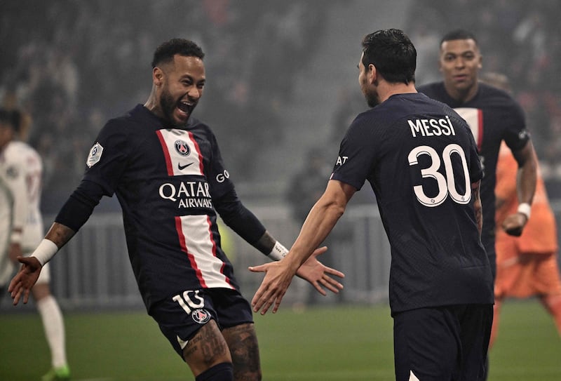 PSG forward Neymar, left, congratulates teammate Lionel Messi on his goal against Lyon. AFP