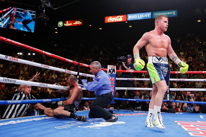 Canelo Alvarez, right, walks to his corner after knocking down Sergey Kovalev during a light heavyweight WBO title bout, Saturday, Nov. 2, 2019, in Las Vegas (AP Photo/John Locher)