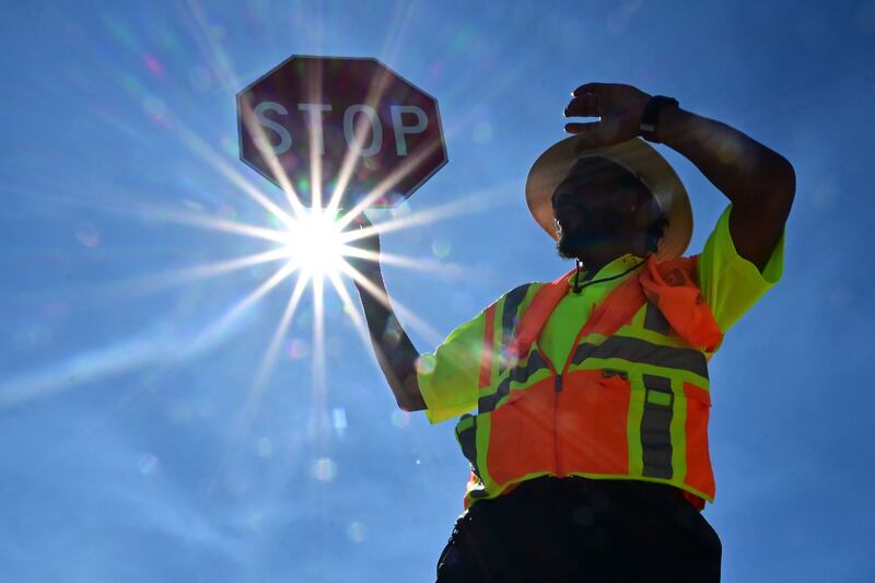 Traffic warden Rai Rogers works on his street corner under the hot sun in Las Vegas. AFP