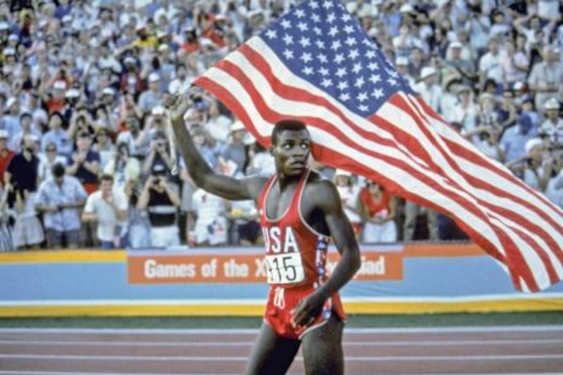 Carl Lewis takes a victory lap around the track of the Los Angeles Coliseum Saturday, August 4, 1984 after winning the gold medal in the 100-meter dash.(AP Photo, The Los Angeles Times/Skeeter Hagler)