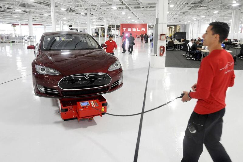 Mark Cuyler, an operations manager at Tesla, walks a Model S through the company’s factory in California. Tesla began delivering the electric sedan to customers on June 22, 2012. Noah Berger / Reuters