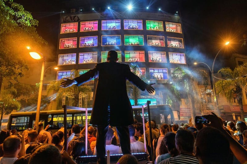 The Batista do Meier Church choir performs during the 4th edition of Christmas Choir at windows in Rio de Janeiro, Brazil, on December 19, 2014. About 200 church members sing from 24 windows of the church’s building following their conductor on the ground. Yasuyoshi Chiba / AFP photo