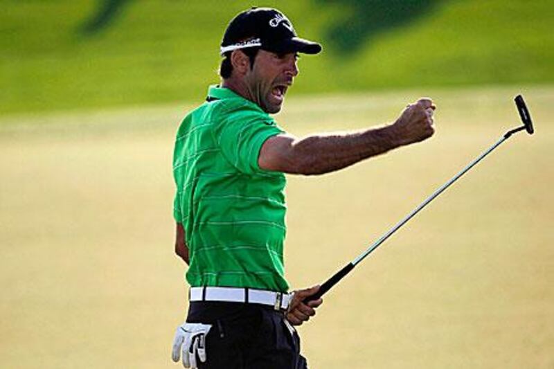 Alvaro Quiros celebrates at the 18th green after holing a monstrous 50-feet putt.