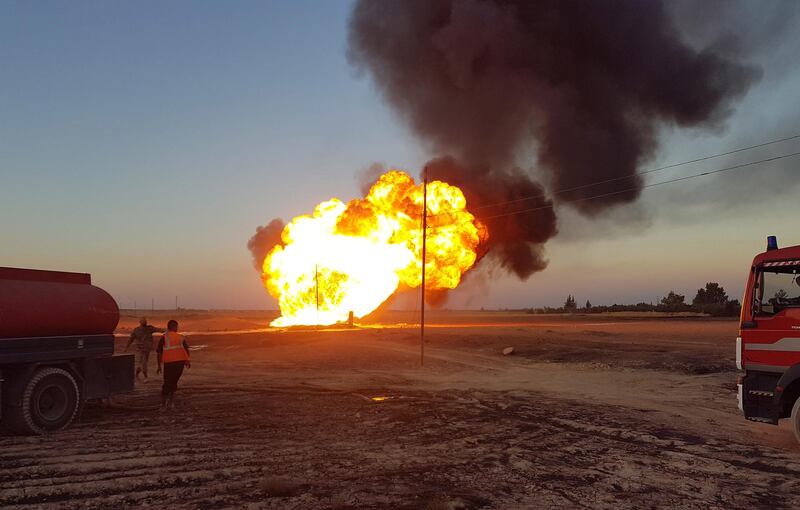 Syrian firefighters extinguish the flames of a gas pipeline that hit by an explosion SANA HO via EPA