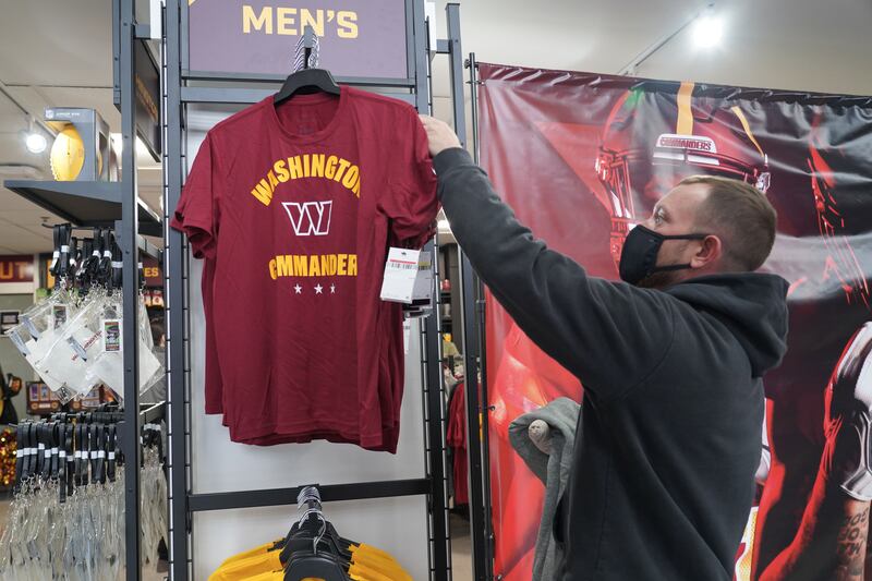 A shopper inspects a new Washington Commanders t-shirt. Willy Lowry / The National.