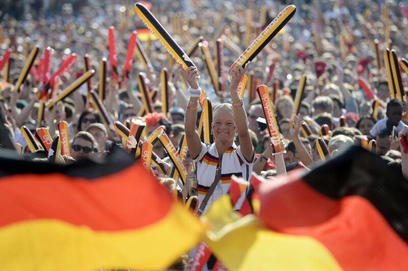 Fans watching the European Championship group C soccer match between Germany and Northern Ireland played at the Parc des Princes stadium in Paris, France, at the fan zone at Brandenburg Gate in Berlin, Germany, Tuesday June 21, 2016. (Maurizio Gambarini/dpa via AP)