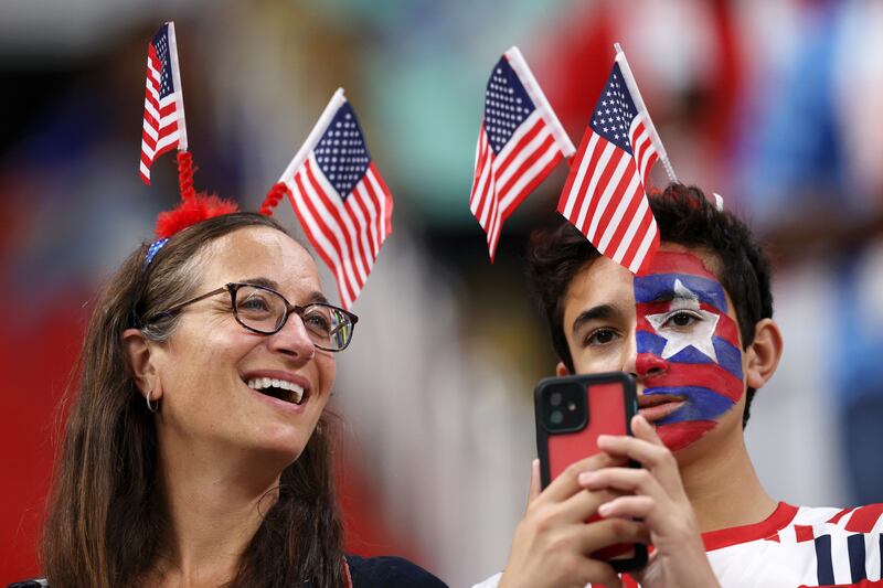 These fans wear their US pride with smiles on their faces. Getty