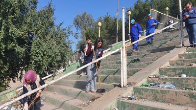 Volunteers sweep steps on the banks of the Tigris. Sinan Mahmoud / The National