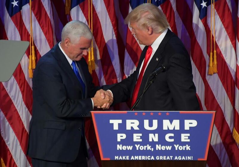 Republican president-elect Donald Trump, right, shakes hands with Republican candidate for Vice President Mike Pence on election night at the New York Hilton Midtown in New York. Jim Watson / AFP