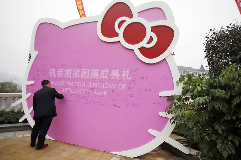 A man signs on a Hello Kitty cut-out during the inauguration ceremony of the Hello Kitty amusement park in Anji, Zhejiang province. Carlos Barria / Reuters