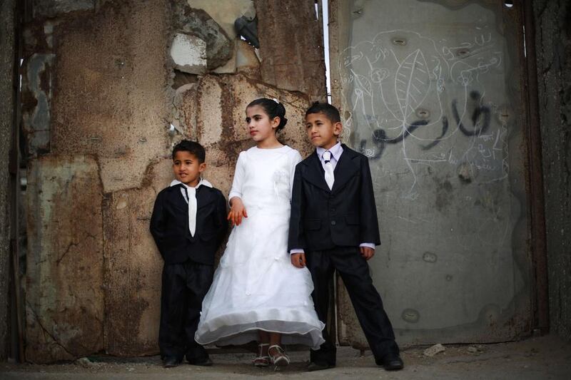Children pose for a photo during one of their relative’s wedding next their home at the Shati refugee camp in Gaza City, Palestine. Mohammed Abed / AFP