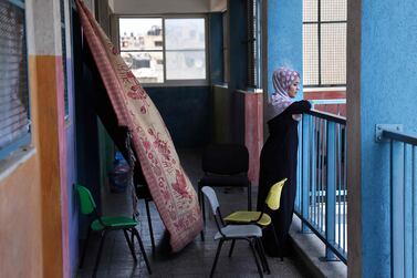 A member from the Abu Ghadyan Palestinian family on the balcony of a school run by the United Nations Relief and Works Agency for Palestine Refugees (UNRWA) where she will be living temporarily with her relatives, after their home was damaged during the recent Israeli bombing in Gaza City, on May 29. AFP