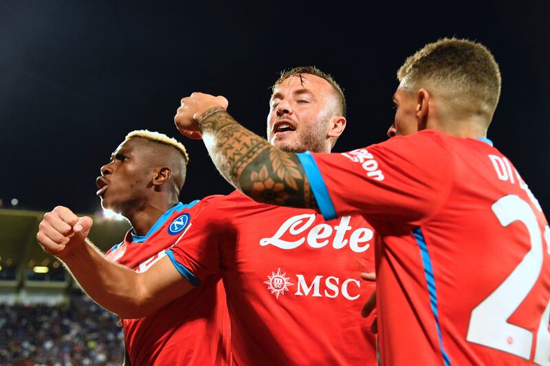 Amir Rrahmani celebrates with teammates after scoring the winning goal for Napoli against Fiorentina. AFP