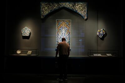 DOHA, QATAR - February 18, 2009: A man looks at mosaic tile artifacts from Turkey, Iran, and central Asia from 13th-15th centuries at the Museum of Islamic Art on the corniche of Doha, Qatar  (Ryan Carter / The National)

*** For Travel story by Mo Gannon 
 *** Local Caption ***  RC058-TravelDoha.jpgRC058-TravelDoha.jpg