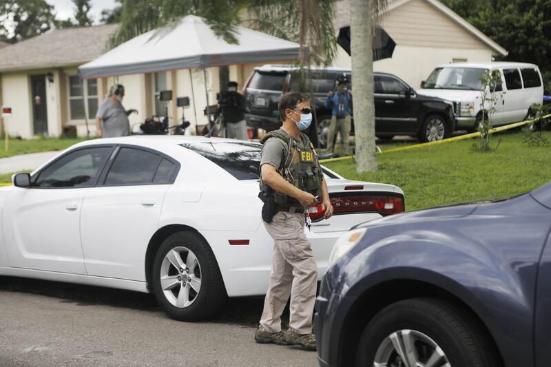 FBI agents take items from the family home of Brian Laundrie in North Port, Florida. AFP