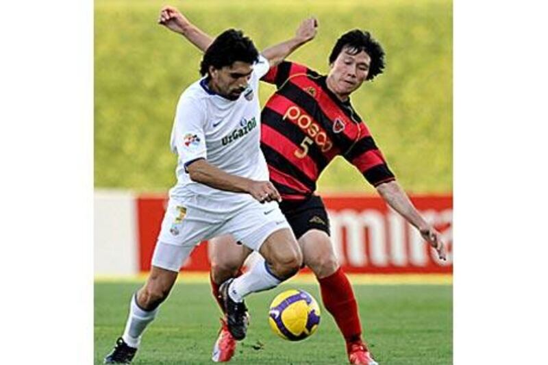 Bunyodkor's Haydarov, left, battles Pohang's Tae Su last week.