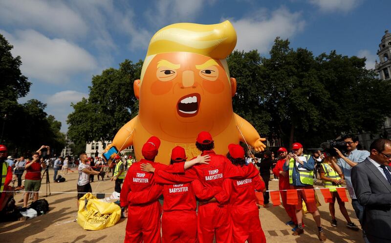 Demonstrators stand in front of the blimp at Parliament Square. Reuters