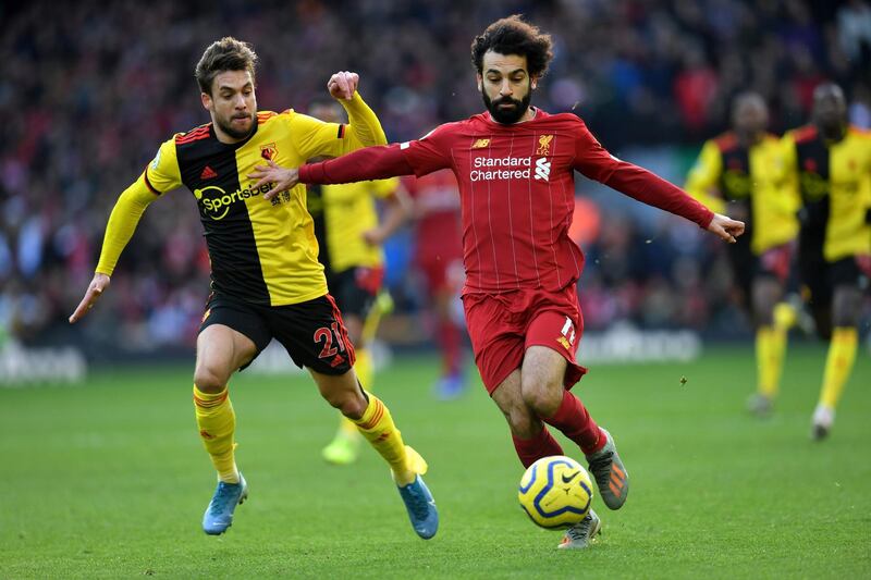 Watford defender Kiko Femenia (L) vies with Liverpool's Mohamed Salah. AFP