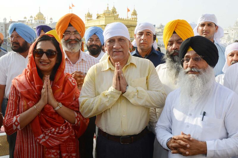 Gen Rawat, centre, and his wife Madhulika Rawat, left, seen paying their respects at the Golden Temple in Amritsar, in 2018.  AFP